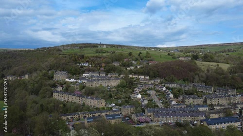 scenic aerial drone shot of the town of hebden bridge with surrounding countryside and old town and midgley moor in the background