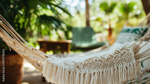 Obraz na płótnie Close up of hammock edge with fringe gently blowing in wind, vintage chair and plant in background w salonie