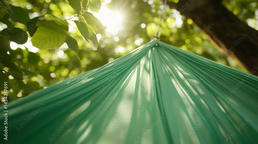 Soft fabric of a hammock stretched between two trees, focus on stitching and fibers, summer theme