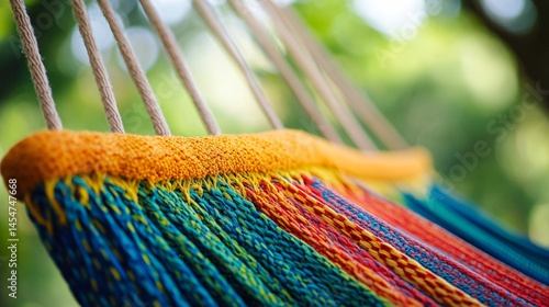 Obraz na płótnie Macro shot of colorful woven threads of a hammock, bright daylight with green jungle backdrop w salonie