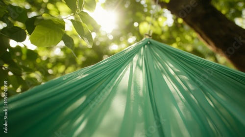 Soft fabric of a hammock stretched between two trees, focus on stitching and fibers, summer theme