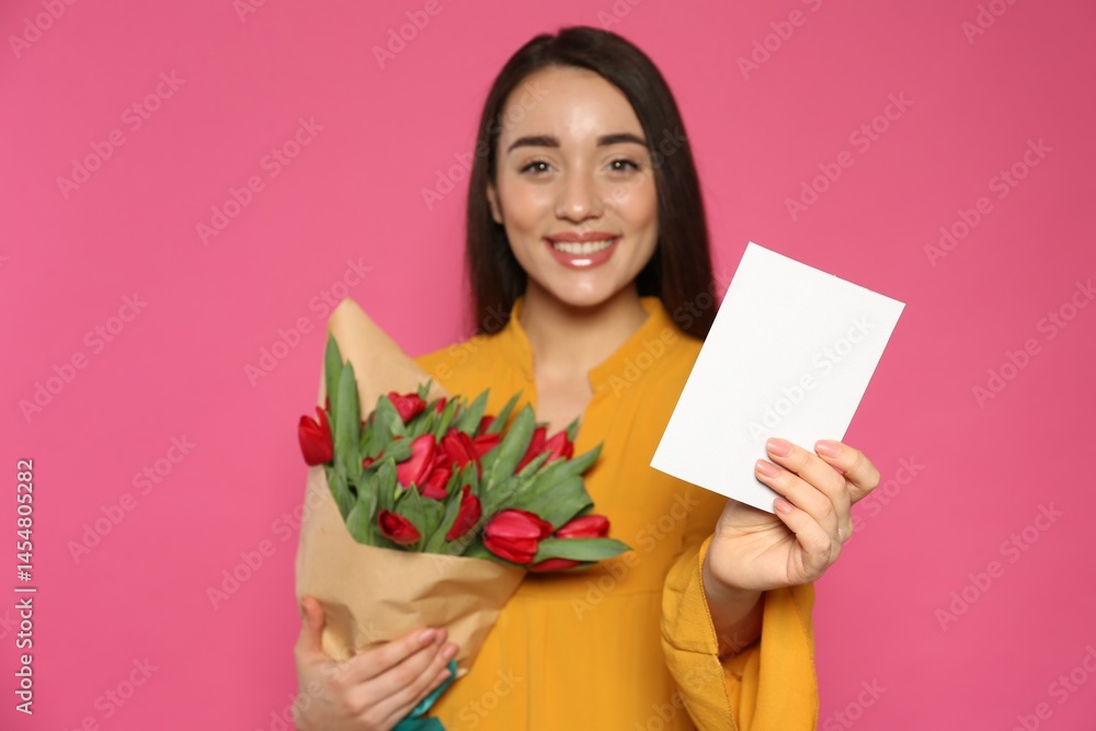 Happy woman with red tulip flowers bouquet and greeting card on pink background. 8th of March celebration Happy woman with red tulip flowers bouquet and greeting card on pink background. 8th of March celebration