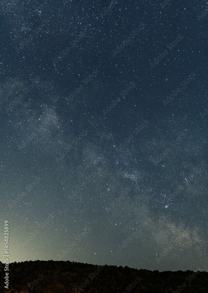 Stunning view of the Milky Way galaxy and countless stars in the night sky. Long exposure astrophotography capturing the beauty of deep space