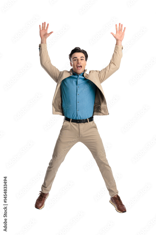 excited casual guy with hands above head jumping in the air and screaming excited casual guy with hands above head jumping in the air and screaming