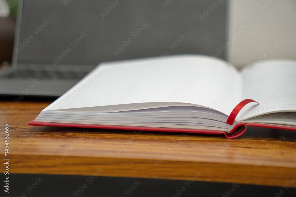Naklejka premium Minimalist Workspace with Red Notebook