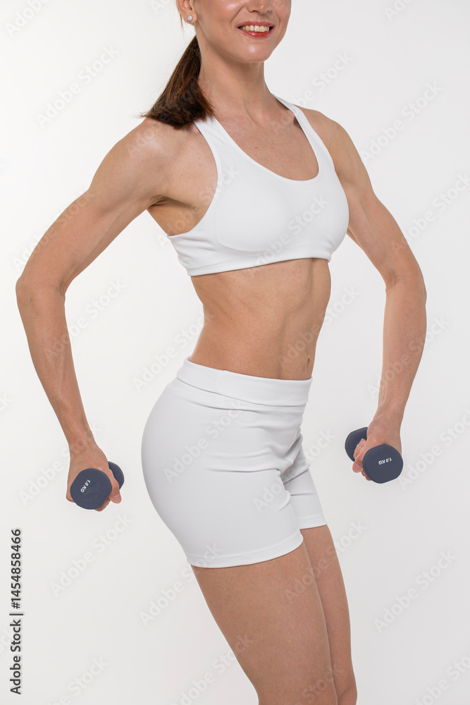Fototapeta premium Athletic and slim female figure in white sportswear