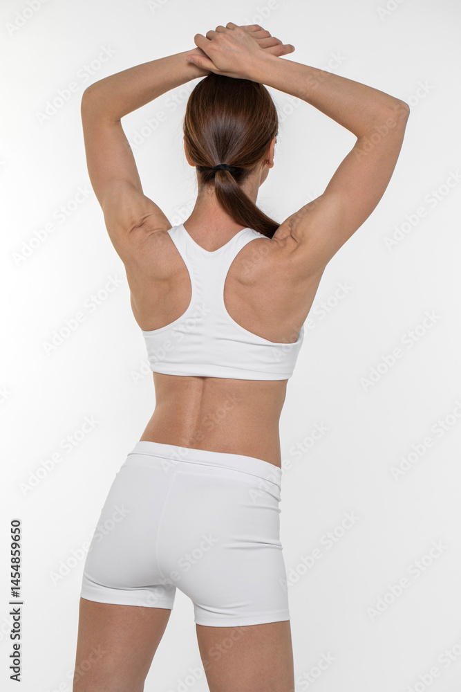 Fototapeta premium Fitness woman. Portrait of a young athletic brunette model