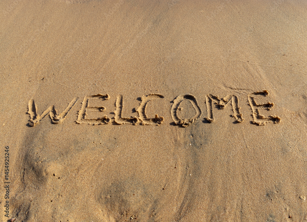 Fototapeta premium Business hello and welcome concept. Concept word Welcome written on beautiful Red sea ocean sand beach. Beautiful Red sea ocean sand beach background, copy space. Business hello and welcome concept.