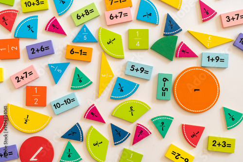 Colorful math manipulatives scattered on a white surface for hands-on learning and educational activities