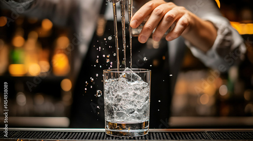 A bartender preparing a highball cocktail with precision and care.