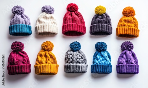 Obraz na płótnie Colorful knitted winter hats arranged on a clean white background, soft textures and vibrant tones creating a cozy winter vibe, high detail, w salonie