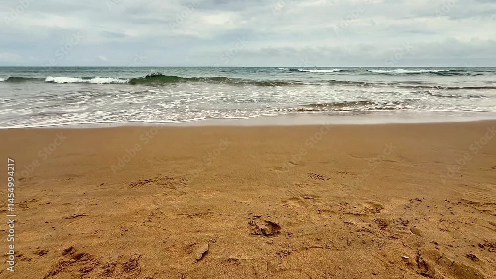 A beautiful and serene seashore featuring gentle waves, soft sandy beach, and peaceful surroundings A beautiful and serene seashore featuring gentle waves, soft sandy beach, and peaceful surroundings
