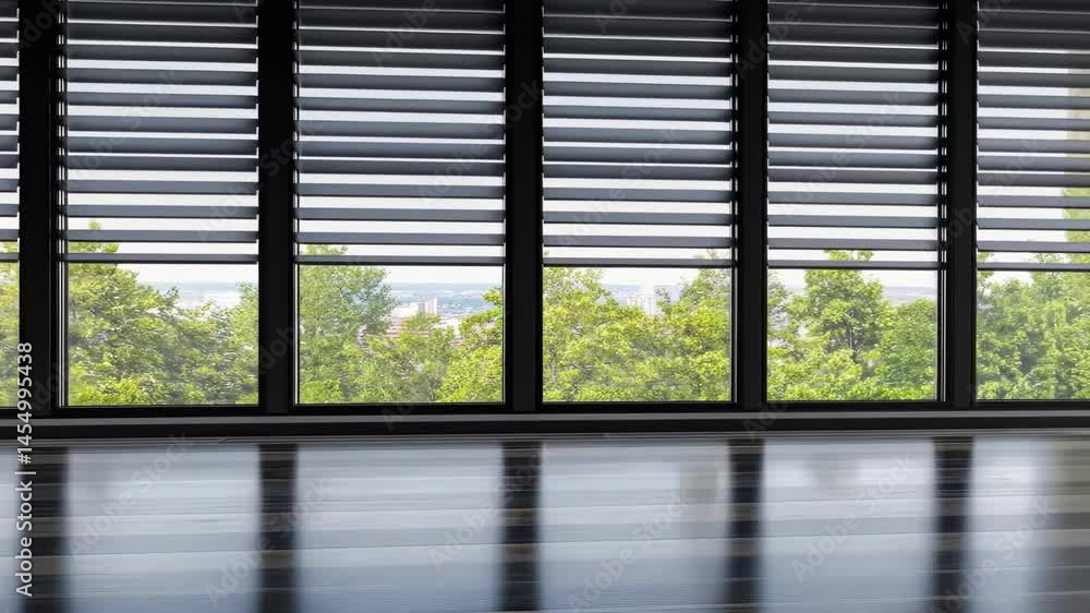 Modern interior with large windows showcasing green trees outside Modern interior with large windows showcasing green trees outside