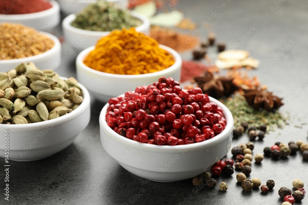 Different aromatic spices on grey table, closeup Different aromatic spices on grey table, closeup