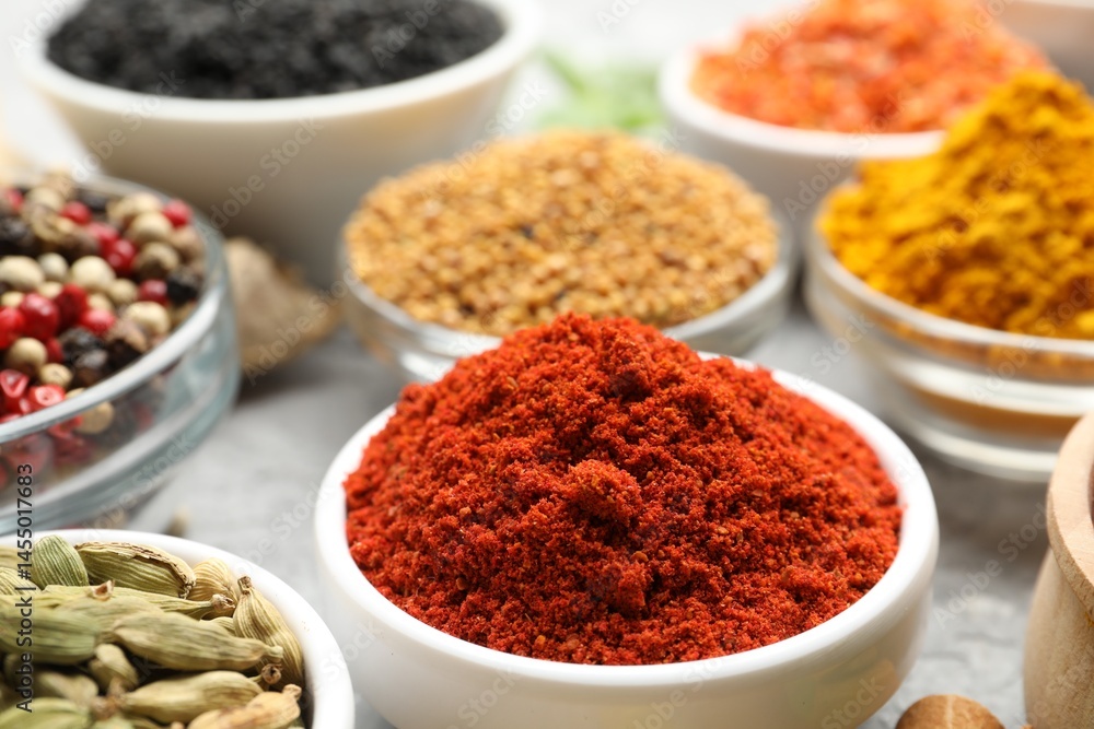 Different aromatic spices in bowls on table, closeup Different aromatic spices in bowls on table, closeup