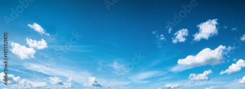 Wide shot of clear blue sky with few clouds for creative projects