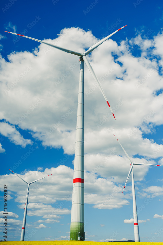 Windmill for generating energy against a blue sky. Windmill in a rural area in Europe.