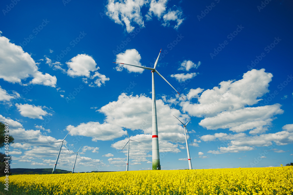 Windmill for generating energy against a blue sky. Windmill in a rural area in Europe.