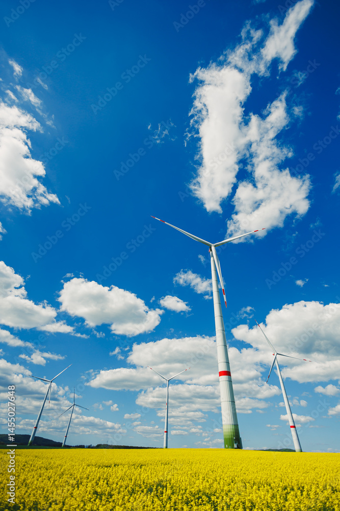 Wind turbine field. Wind turbines generating energy against a clear blue sky. Wind turbines generating clean renewable energy in a rural field.