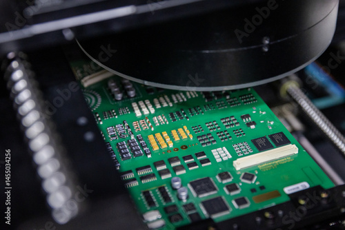 Russia. Moscow. Conducting non-destructive testing on an electronic circuit board.