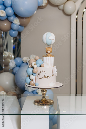 Obraz na płótnie Sweet cake for a child's birthday decorated with a teddy bear. Two-story cake for a child. 1st birthday party for a child. w salonie