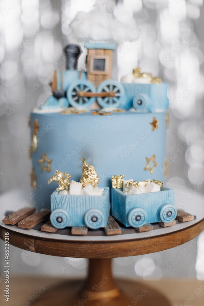 Cake for a children's birthday celebration with trains. Blue birthday cake. Cute sweet dessert with trains for the birthday boy.