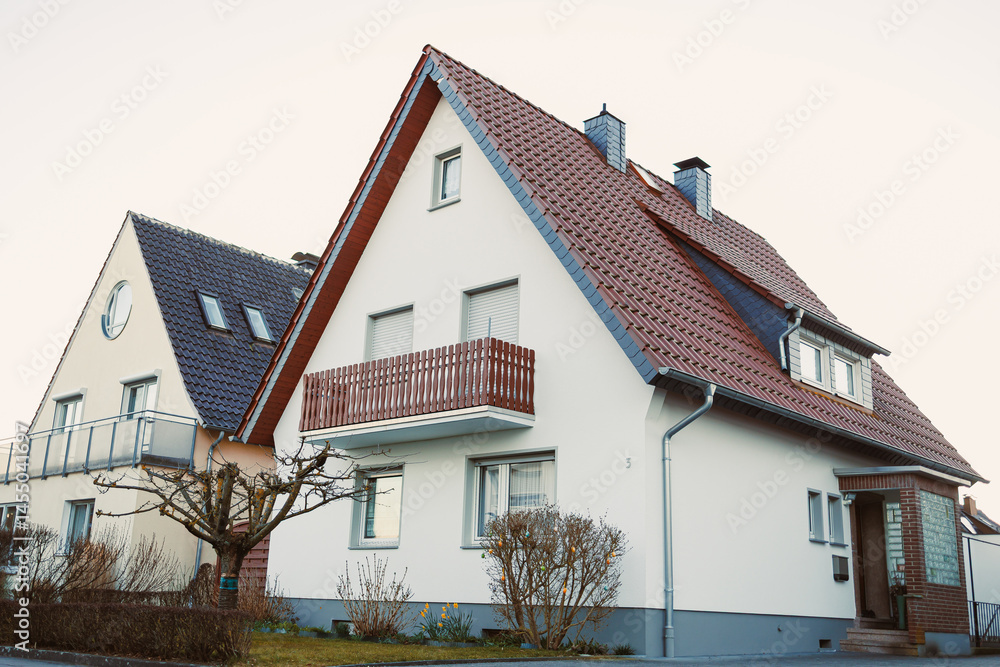 Exterior facade of the house. Landscape design of the house area. European house. Roof on the house made of tiles.