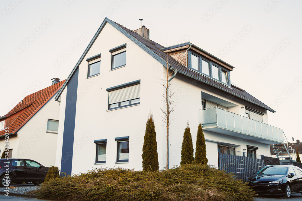 Exterior facade of the house. Landscape design of the house area. European house. Roof on the house made of tiles.