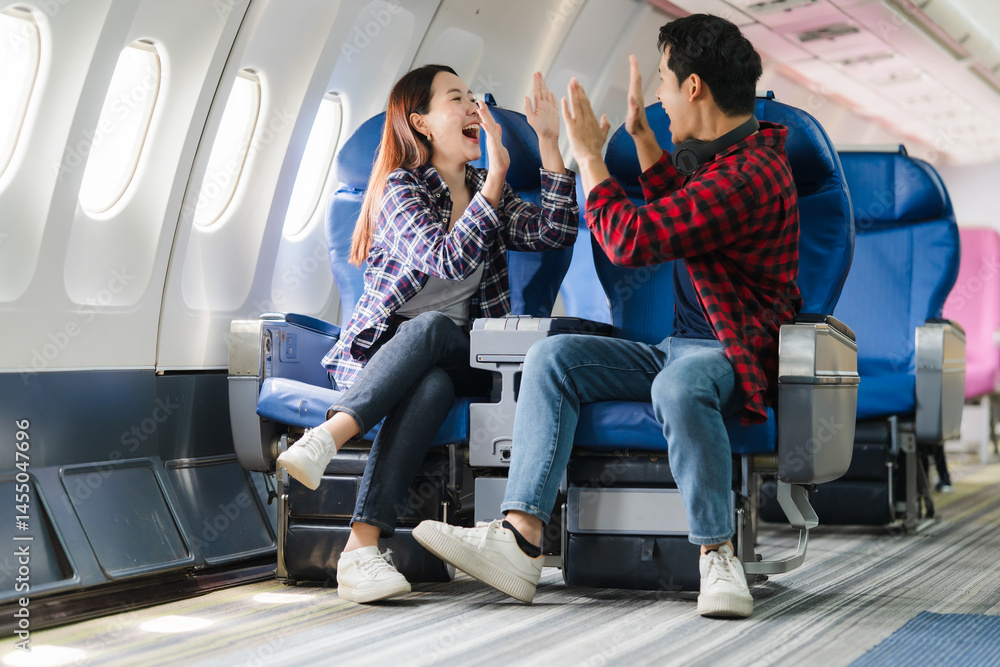 Happy Couple High-Fiving on Airplane