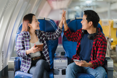 Couple Celebrating Success on Airplane