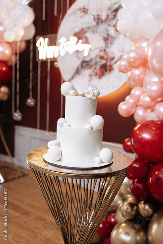 Obraz na płótnie Pink first birthday cake with teddy bear figurine. Soft pastel colors and festive decoration create a warm, festive atmosphere. Sweet cake for a one-year-old birthday girl w salonie