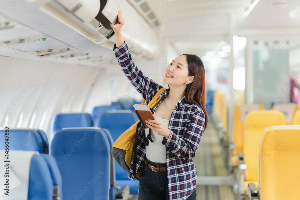 Woman Stowing Luggage on Airplane