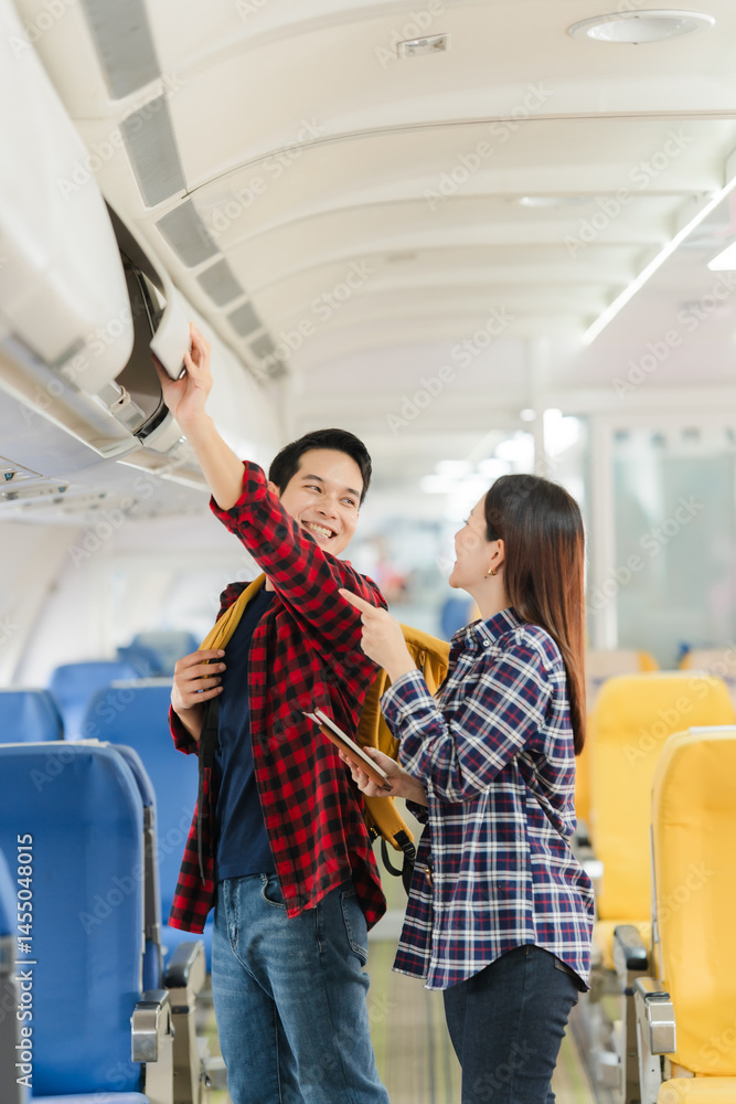 Couple Stowing Luggage on Airplane