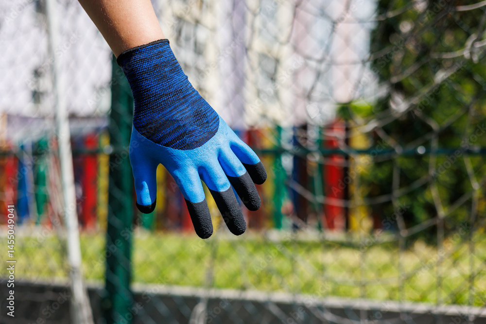 Rough gloves on men's hands for a construction worker. Construction gloves. Durable gloves for dirty work. Garden gloves. Rubberized construction gloves.