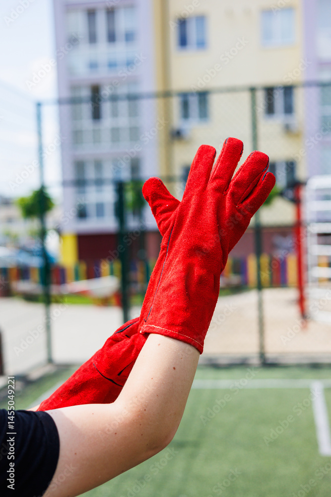 Rough gloves on men's hands for a construction worker. Construction gloves. Durable gloves for dirty work. Garden gloves. Rubberized construction gloves.