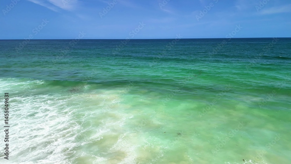 Obraz premium Experience a Serene Coastal View featuring Turquoise Waters and Gentle, Relaxing Waves