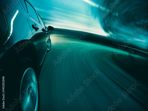 Close-up side view of a Car driving at speed on curved road at night, Illinois, USA