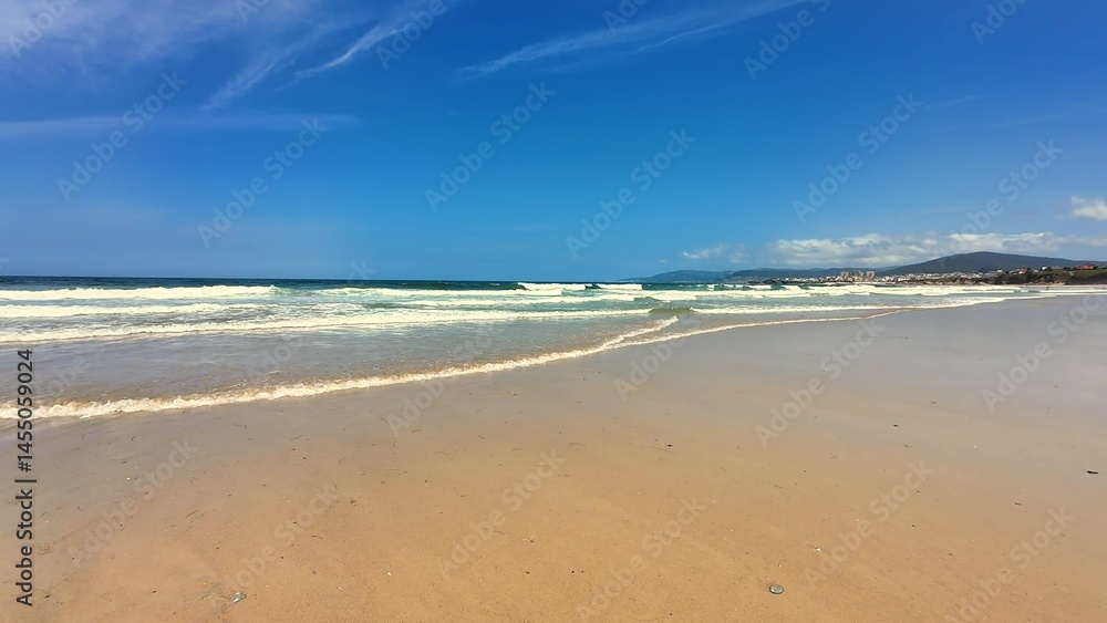 Experience the serene and beautiful beach view under a clear and expansive blue sky Experience the serene and beautiful beach view under a clear and expansive blue sky