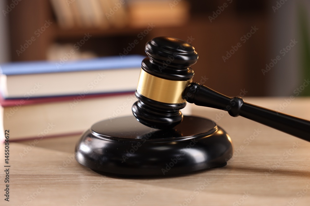 Judge's gavel and books on wooden table indoors, selective focus Judge's gavel and books on wooden table indoors, selective focus