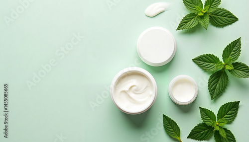 Obraz na płótnie Cream jars with mint leaves on a light green background, Mint leaves collection, Herbal tea picking w salonie