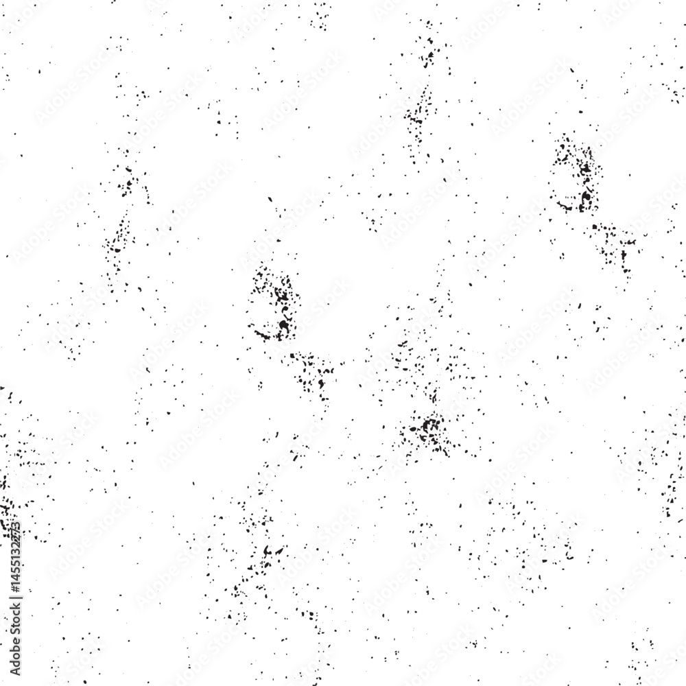A textured white background displays numerous small dark dots scattered across the surface. A textured white background displays numerous small dark dots scattered across the surface.