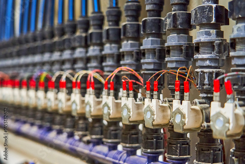 Close-up of an Organized Array of Solenoid Valves and Piping in an Industrial Fluid Control System
