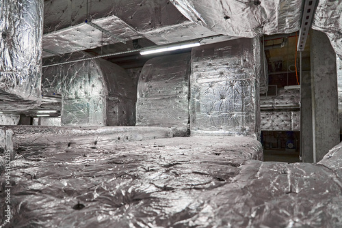 Extensive Network of Insulated Ductwork and Piping for Ventilation and Climate Control Systems within a Building Interior