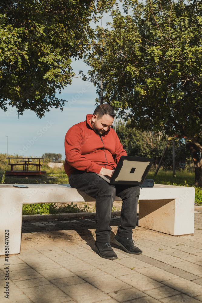 Employee Working Hard On His Laptop At The Park