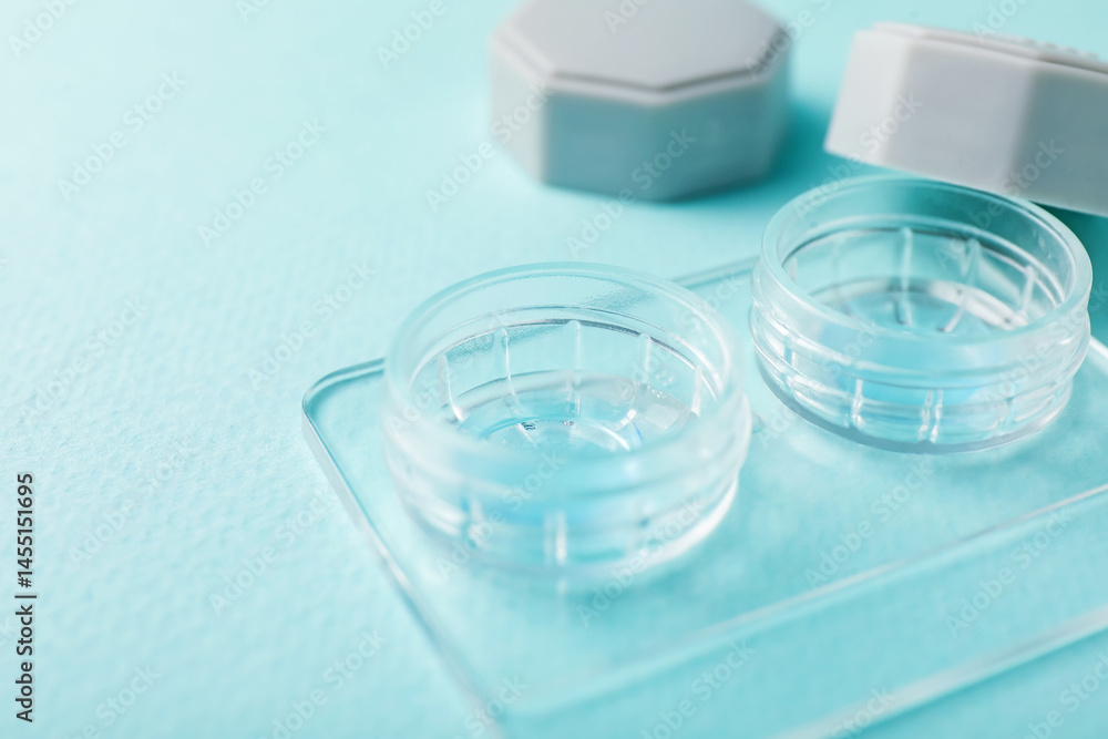 Contact lenses in case on light turquoise background, closeup Contact lenses in case on light turquoise background, closeup