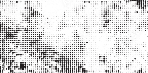 A dense array of small white dots contrasts sharply against a black background creating a textured abstract .