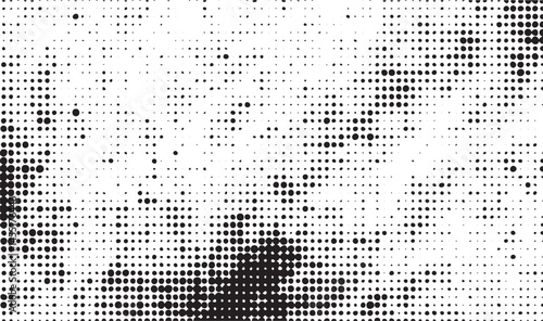 A dark textured of numerous small black dots contrasts against a white background.