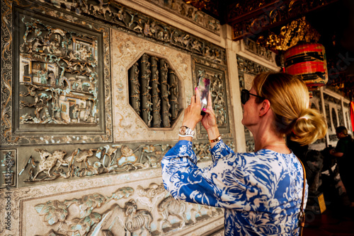 Penang, Malaysia - February 28, 2025: A woman taking pictures at the Khoo Kongsi Temple in the Georgetown district of Penang, Malaysia
