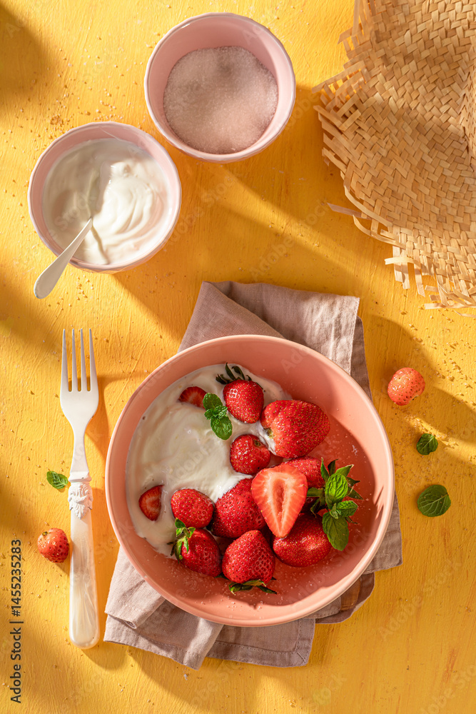 Tasty and homemade strawberries with sugar and yogurt.
