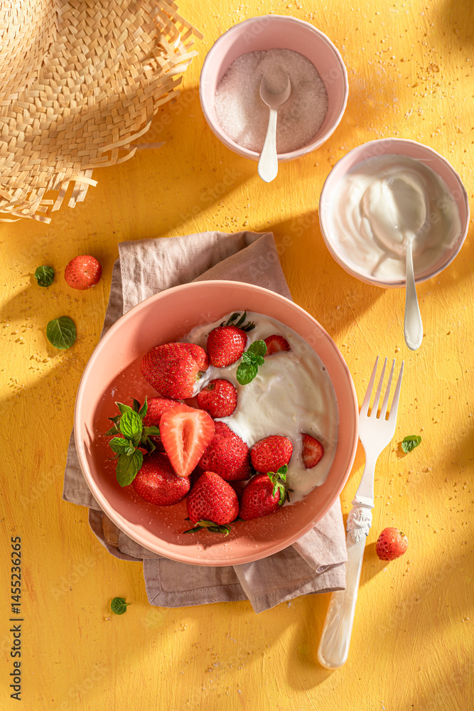 Creamy and delicious strawberries with sugar and yogurt.